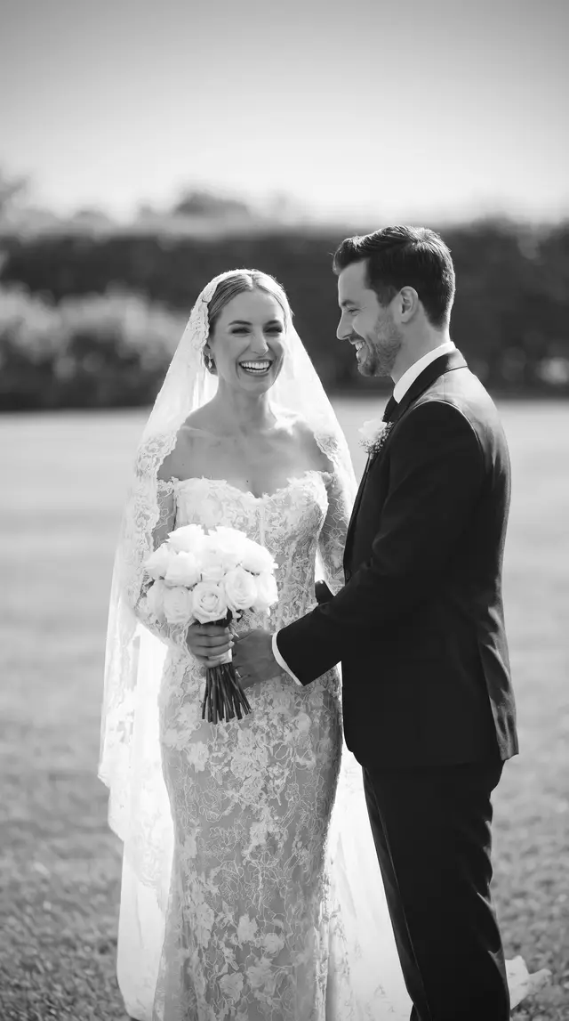 Bride in a custom VI Dressmakers full-lace off-the-shoulder mermaid gown, laughing with her groom at an outdoor Australian vineyard wedding