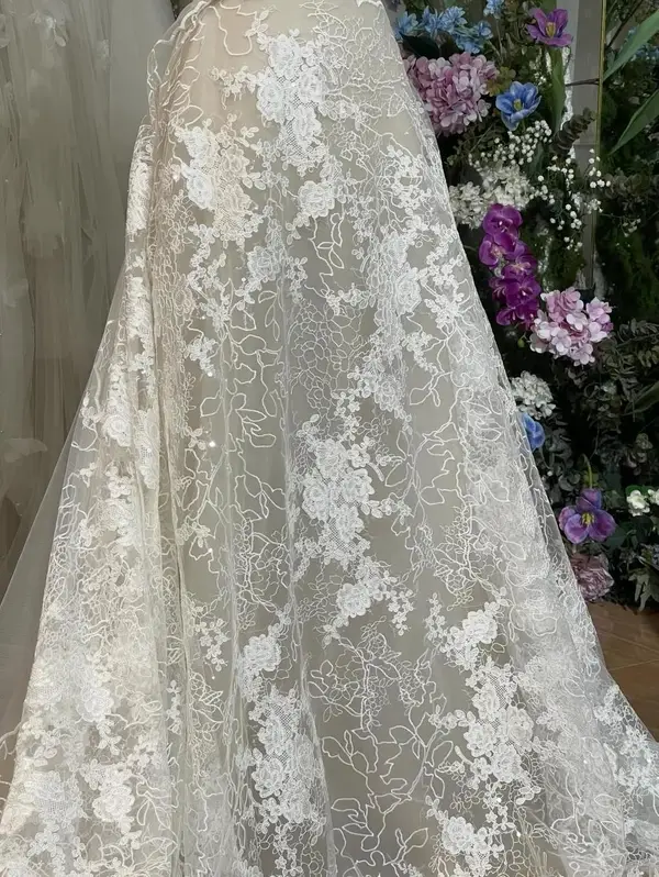 Floral bridal lace over soft nude lining, material direction for Amelia's custom mermaid wedding dress by VI Dressmakers Vietnam