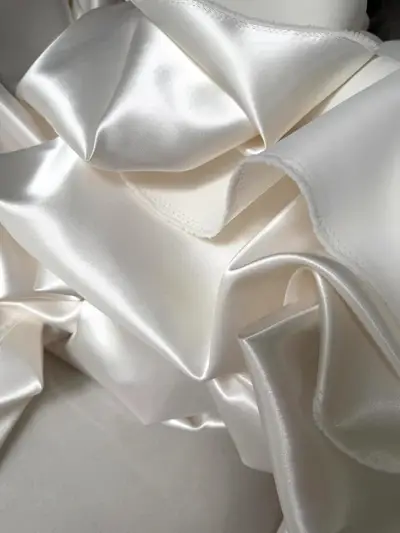 Heavy ivory satin fabric swatch reviewed by VI Dressmakers Vietnam before cutting Mei Lin's corset A-line wedding dress