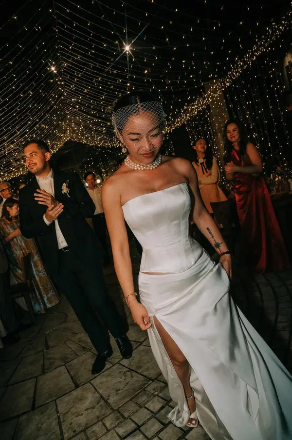 Ivory satin corset A-line wedding dress with birdcage veil and pearl necklace, custom-made by VI Dressmakers Vietnam for Singapore