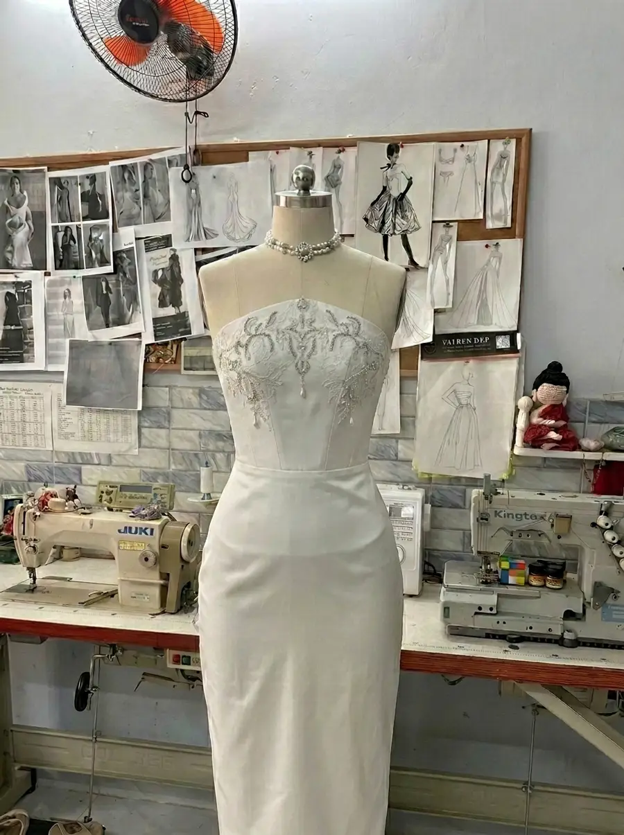 Crystal-embroidered strapless column gown in progress at VI Dressmakers Vietnam atelier during production