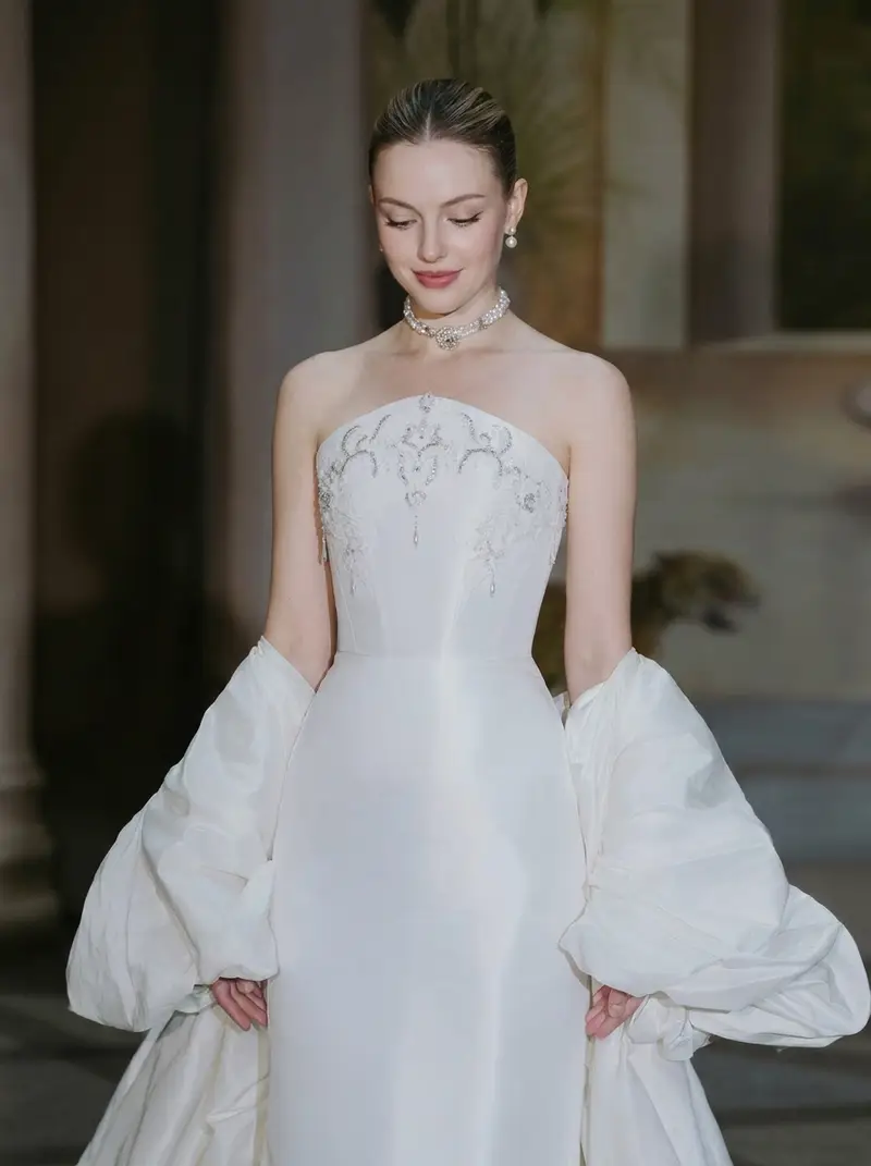 The long-held runway reference Sofia shared — strapless gown with crystal scrollwork and detachable puff sleeves