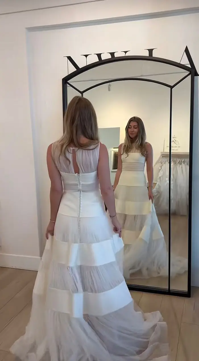 Client inspiration — buttoned back and keyhole in a salon mirror try-on